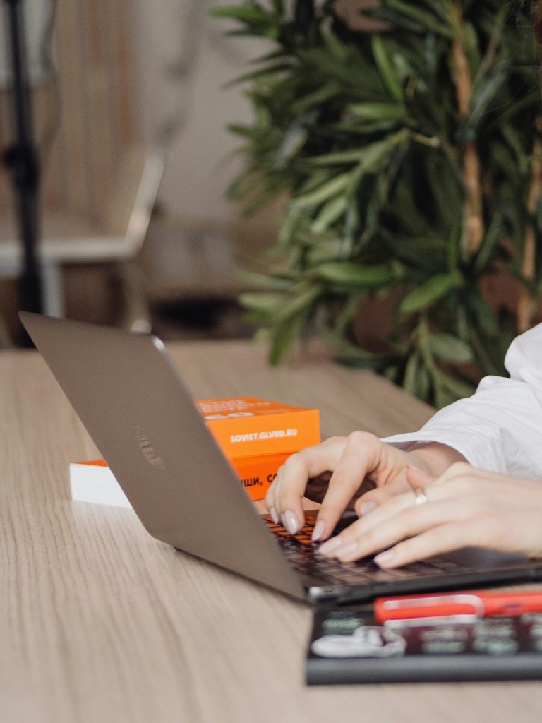 person in white dress shirt using black laptop computer